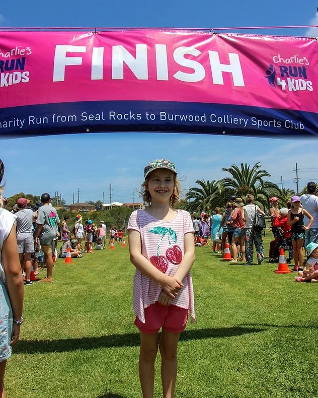 Charlotte &ldquo;Charlie&rdquo; Carr at the finish line of an early Charlie's Run 4 Kids