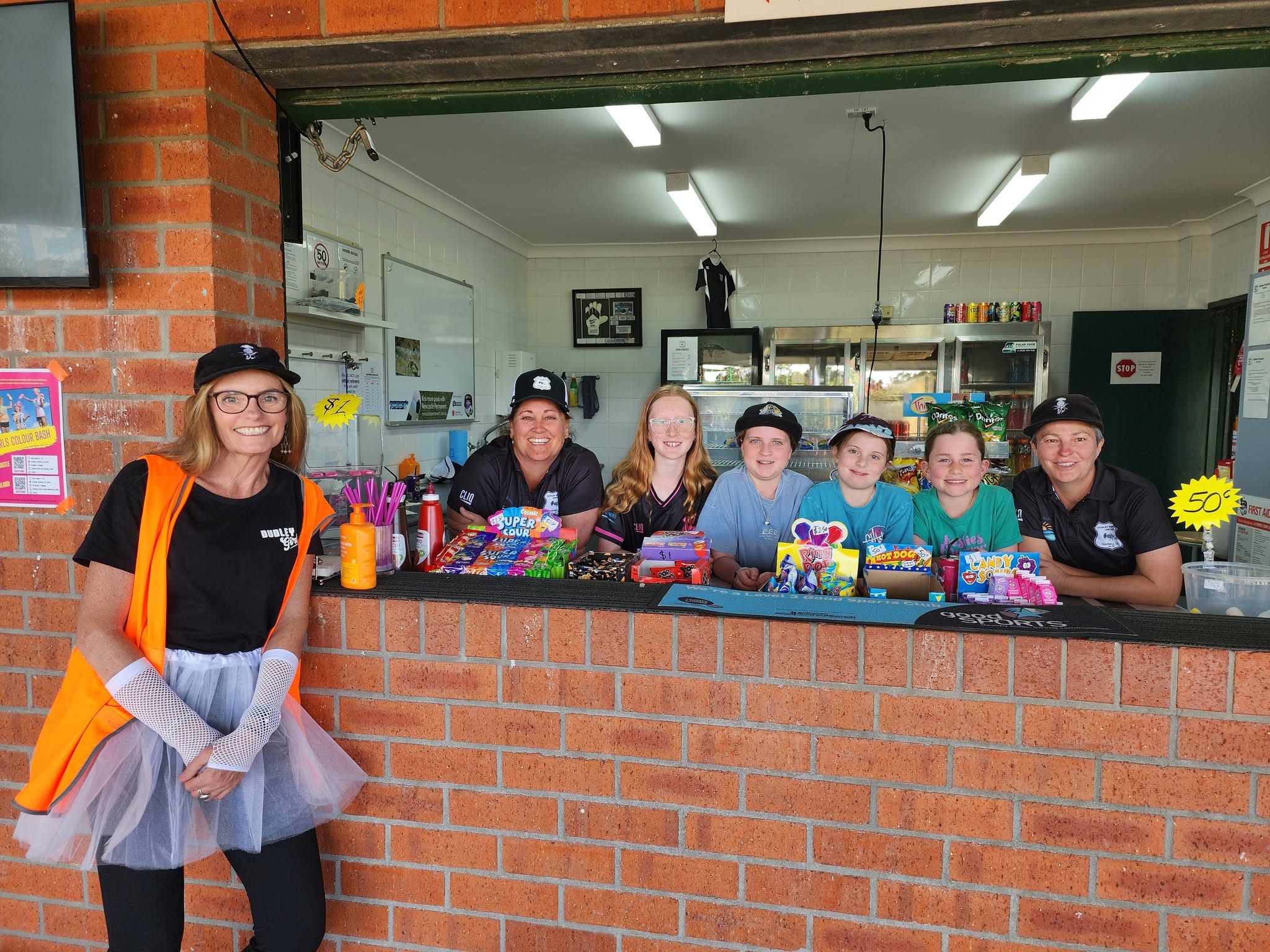 Dudley Redhead volunteers and kids at the club canteen on a community event day