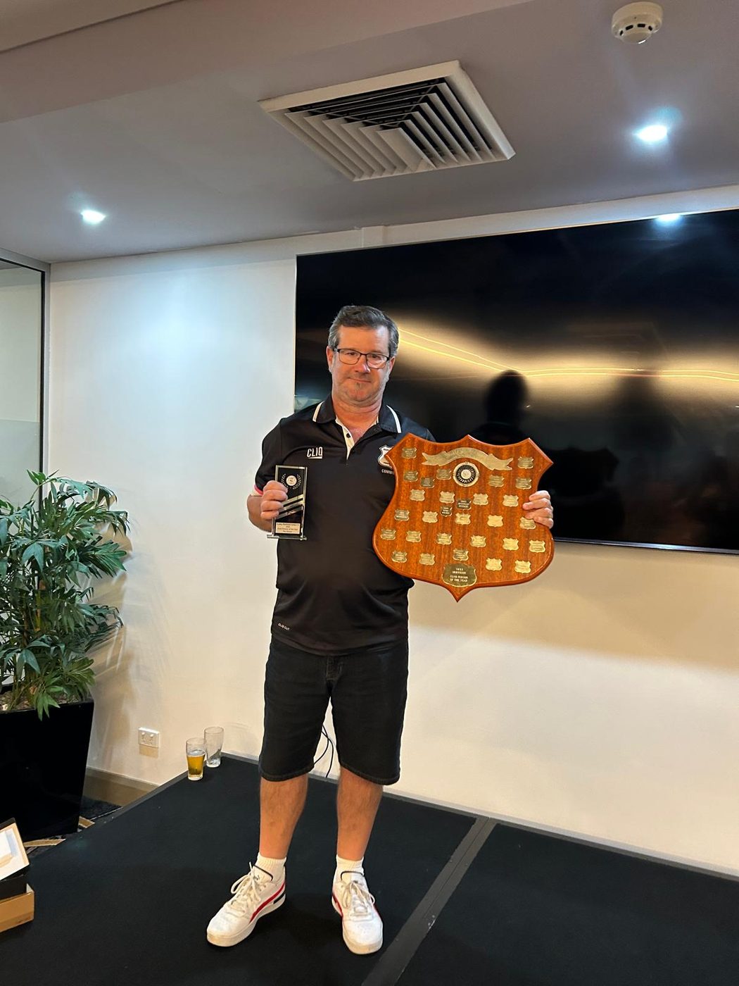 A DRUFC committee member with the Club Person of the Year shield